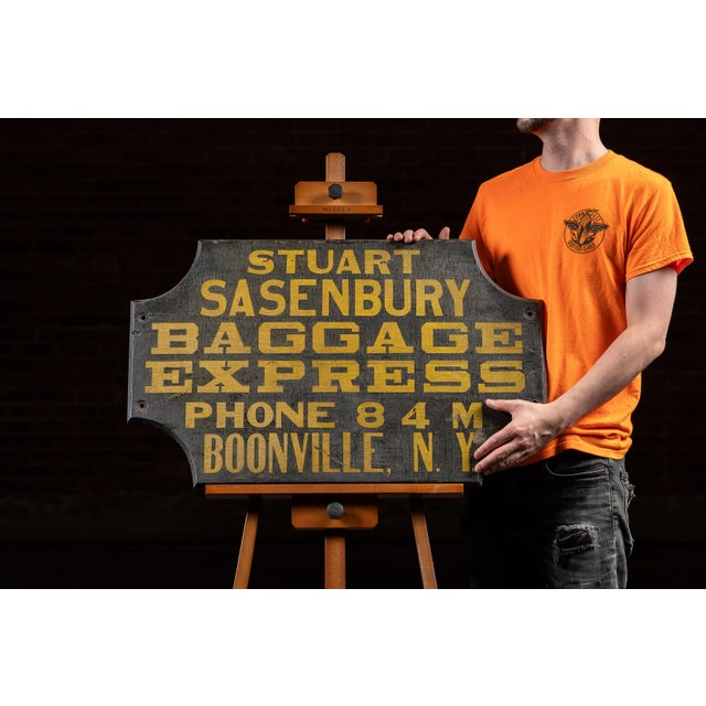 This double-sided hand-painted wooden trade sign with bold yellow block lettering on a field of worn black advertises the...