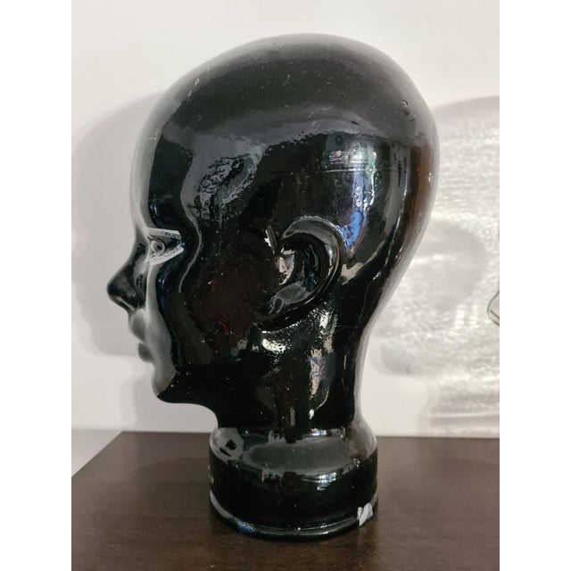 A unique set of four glass display heads made of thick, pressed glass. The set includes four color variations: cobalt,...