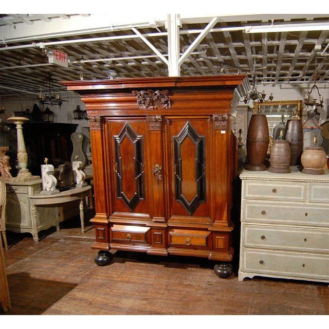 A Swedish 18th century period Baroque cabinet from the 1700s with geometric patterns, tree carving below the escutcheon...