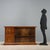 Art Deco display cabinet with walnut burl veneer. Pair of sliding glass doors with height-adjustable internal shelf. On...