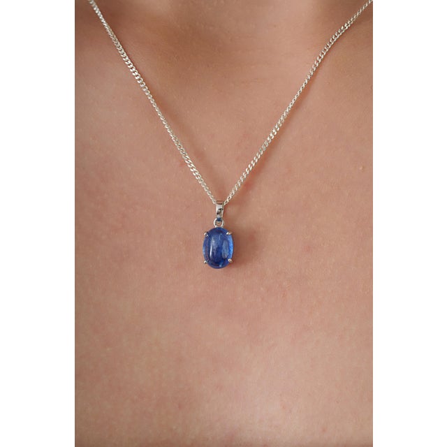 This solitaire pendant feature 3.23 carats of oval blue sapphires set in 14K white gold. The sapphire measuring 7 x 9.8...