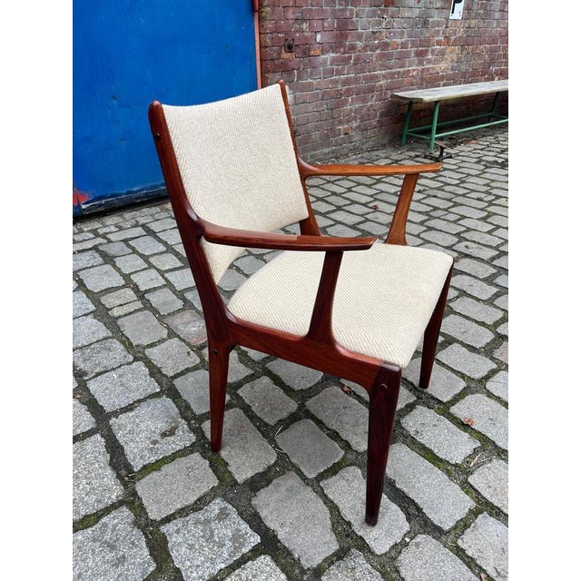 This armchair in dark rosewood, designed by Johannes Andersen for Uldum Møbelfabrik, is a classic example of Danish mid-...