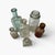 A beautiful antique set of six glass bottles, each with its own subtle variations in shape, clarity, and character. These...