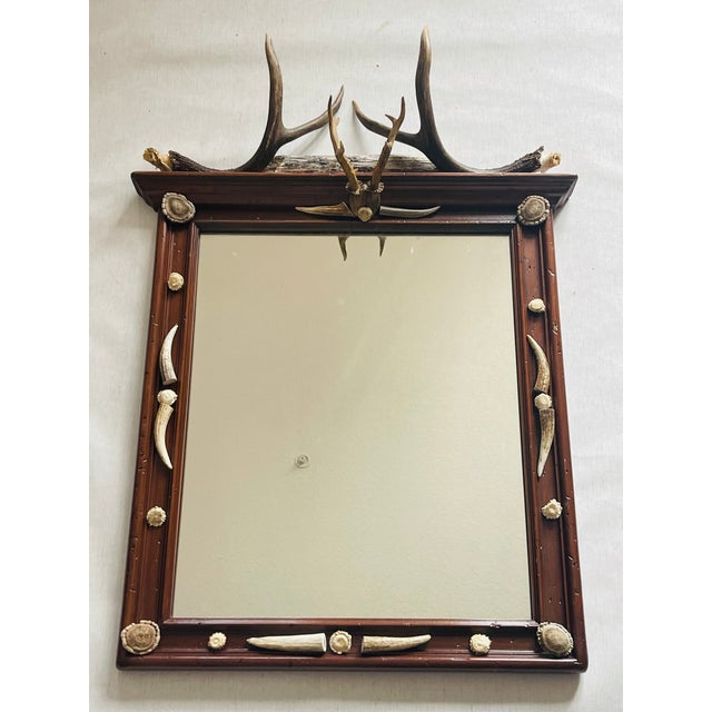 Antique Black Forest wall mirror decorated with roe deer antlers, antler tips and borrows.