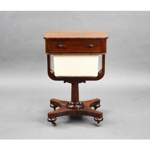 Good quality William IV mahogany work table, having a single drawer over a basket, above the stem terminating on a...