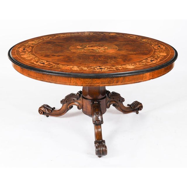 This is a stunning and rare antique Victorian marquetry loo table, circa 1860 in date. Thestriking burr walnut top has the...