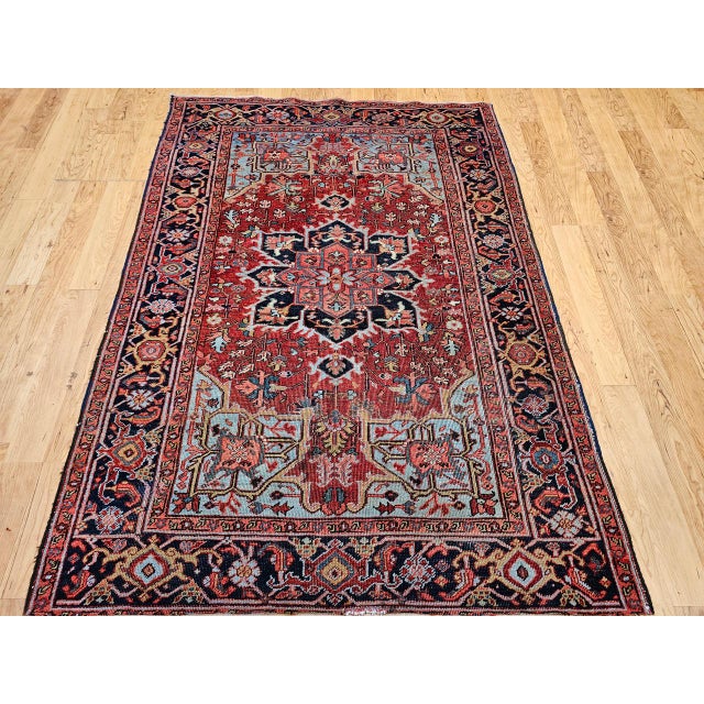 "An exceptional hand-knotted Persian Heriz Serapi rug from the early 20th century, this piece embodies the refined...