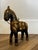 This is a vintage handcrafted wooden horse figurine originating from India.It features intricate hammered brass, copper,...