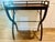 Sophisticated and functional, this mahogany drinks table features elegant curule-style legs and a non-removable top tray....