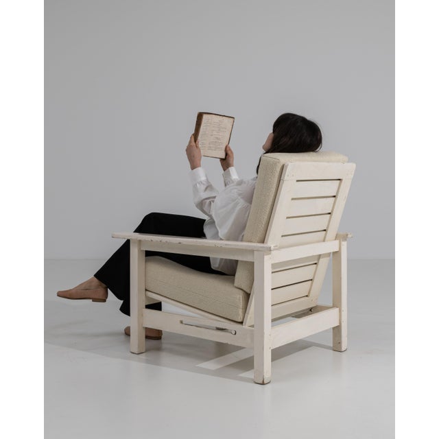 A mid-20th century reclining lounge armchair featuring a structured form with an adjustable backrest. The design...