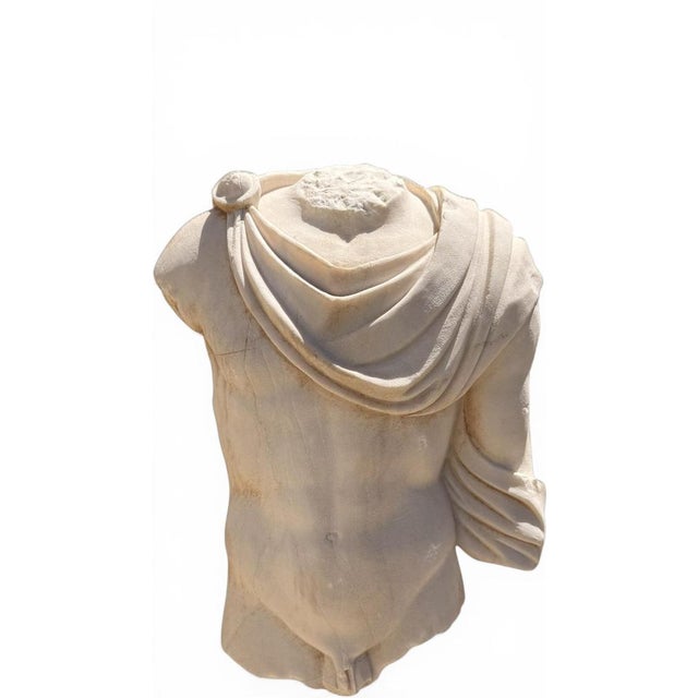 Elegant Greek-style marble torso sculpture created during the 1950s, inspired by the celebrated fragmentary sculptures of...