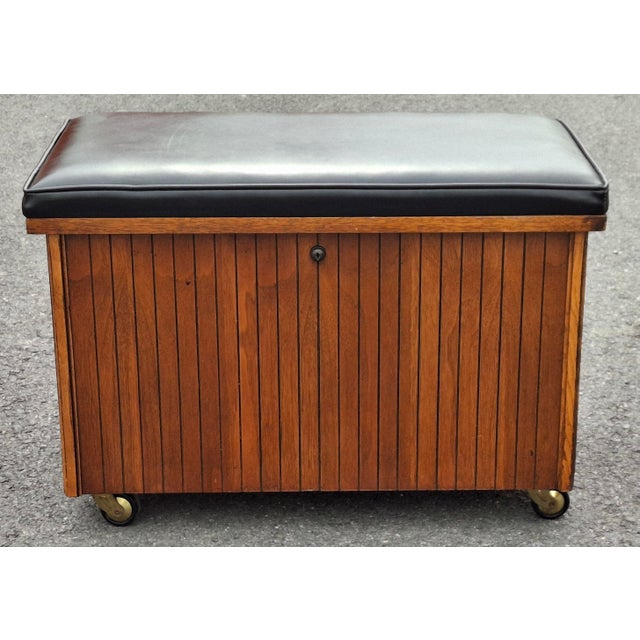 A Lane Furniture trunk crafted for use as a record cabinet and Bench. Original black Naugahyde upholstered top. Divided...