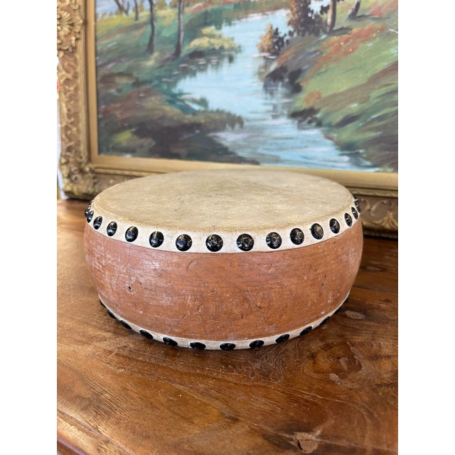 Vintage handcrafted frame drum featuring what is most likely a natural rawhide drumhead stretched over a rounded possibly...