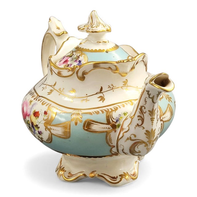 An elegant Paris porcelain teapot dating to around 1840, combining a gently scalloped profile with a turquoise ground and...
