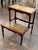 Two tiers, each inset with a leather panel worn to a soft greenish gold, make up these 19th century English mahogany...
