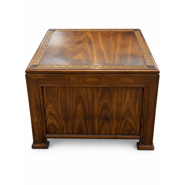 A handsome vintage Mediterranean Revival–style cabinet end table featuring a warm medium-brown finish, substantial paneled...