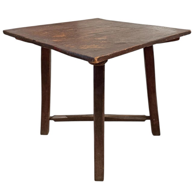 Found in Northern Wisconsin, this early 20th-century American pine square table carries the quiet authority of the...