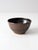 This vintage studio pottery bowl showcases a rich, deep brown glaze with mottled earthy accents. Its organic shape and...