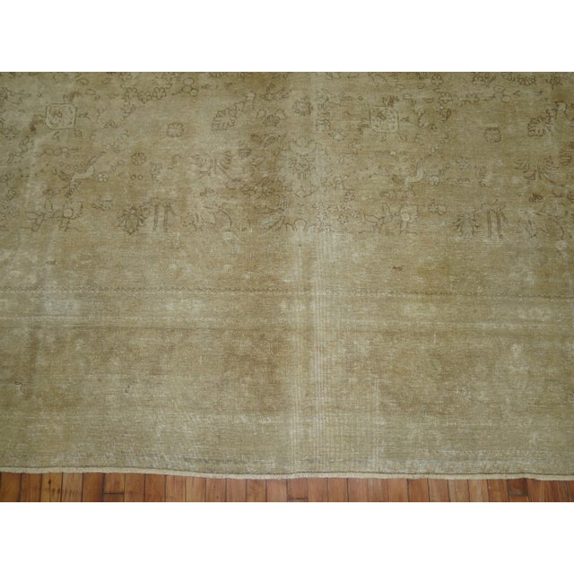 A 2nd quarter of the century Persian Tabriz with a faded pale design throughout Measures: 11'2'' x 14'3''.