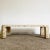 Exceptional vintage postmodern tessellated stone coffee table. Features a pink stone with brass inlays browsed to the...
