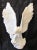 This Italian white glazed terra cotta eagle sculpture from the 1960s is a monumental piece that stands at 35.5 inches tall...