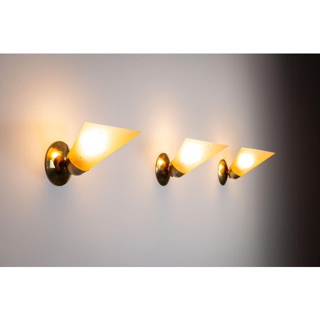 This vintage set of three brass sconces embodies classic elegance and decorative craftsmanship. Each sconce is made from...