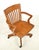 Antique swivel oak office chair, often referred to as the banker's chair, manufactured in the early 20th century. It...