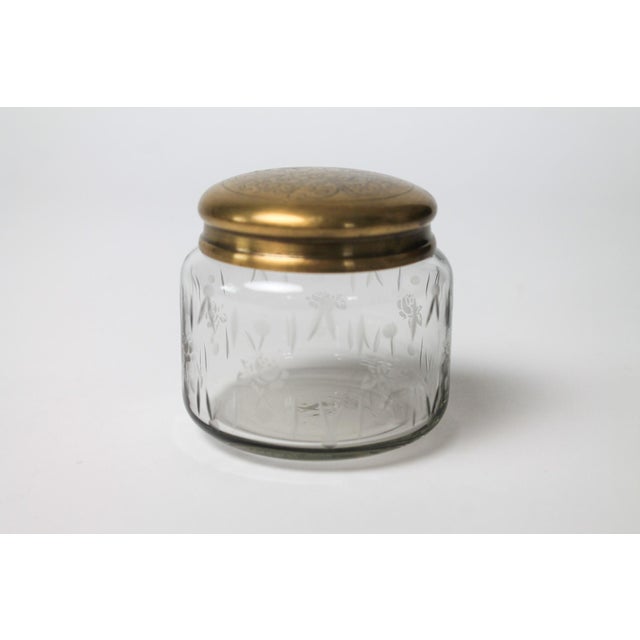 Vintage glass vanity jar with etched brass lid. No makers mark. Minor age wear. Patina.
