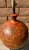Mid century modern large pottery lamp. Rounded ceramic with abstract dark red orange textured paint. Wooden base. Harp is...