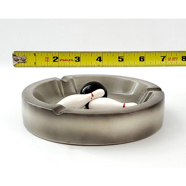 Offering a unique Trompe l'oeil Pop Art sculptural ash tray made in porcelain and signed on the bottom with a red label:...