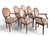 This Set of Six Louis XVI Revival Walnut Dining armchairs by W. & J. Sloane, with woven oval, neutral-toned upholstered...
