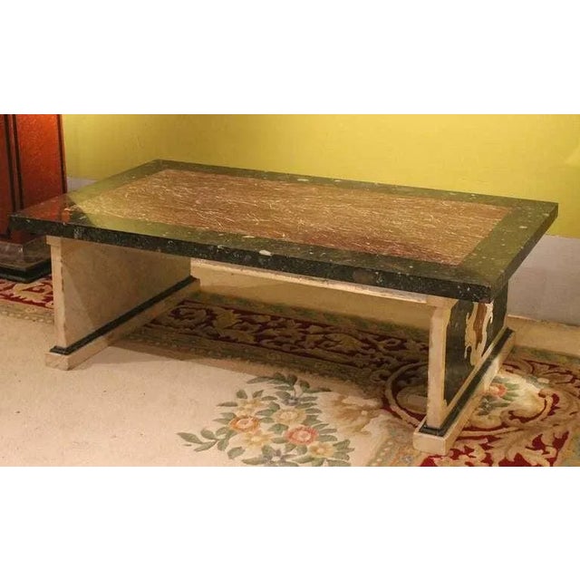 This Florentine early 20th Century rectangular low coffe table expresses all Italian mastery in marble's selection and...