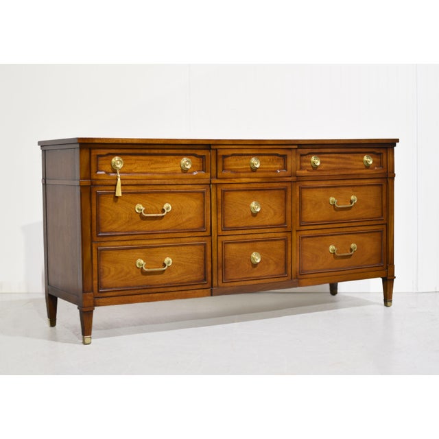 Classic in proportion and rich in detail, this mid century transitional lowboy dresser by Drexel is a standout piece....