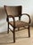 This striking Art Deco chair features a curved bentwood frame with distinctive rounded armrests and clean geometric lines...