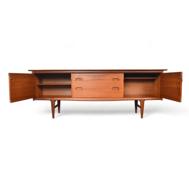 Origin: England Designer: Unknown Manufacturer: A. Younger Ltd Era: 1960s Materials: Teak, Afromosia Measurements: 82.5″...
