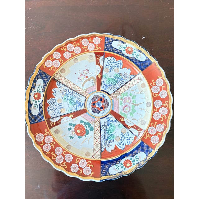 Large Japanese Imari porcelain charger, Meiji period (late 19th–early 20th century). Hand-painted radial panel design with...