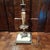 Antique lamp with ornate metal work and marble/stone accents. Does have a lampshade that is not original. In good antique...