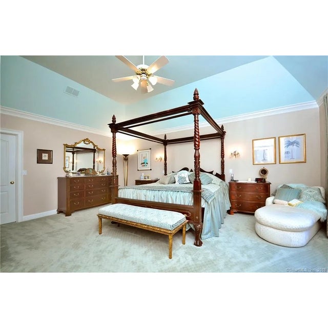Antique American Carved Mahogany Four-Poster King Bed, c. 1880-1910 A substantial antique four-poster bed in carved...