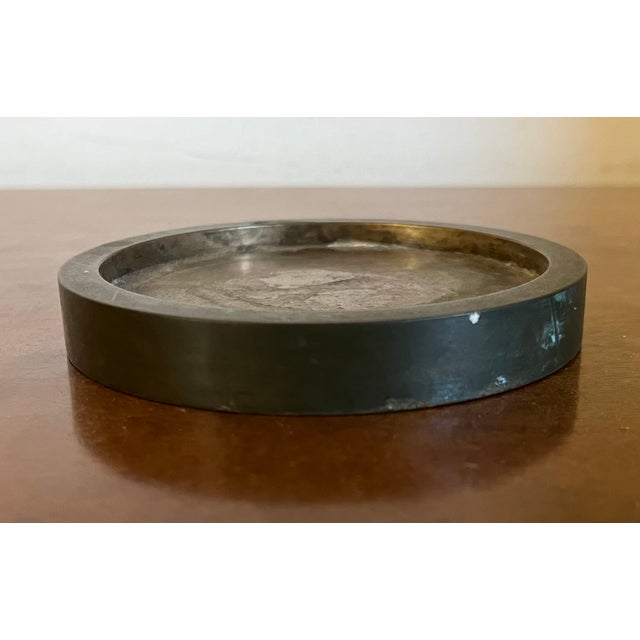 Mid-Century Modern bronze wine bottle coaster. Heavy weight. Measures 4 1/16" diameter x 1/2" thick. Good condition with...