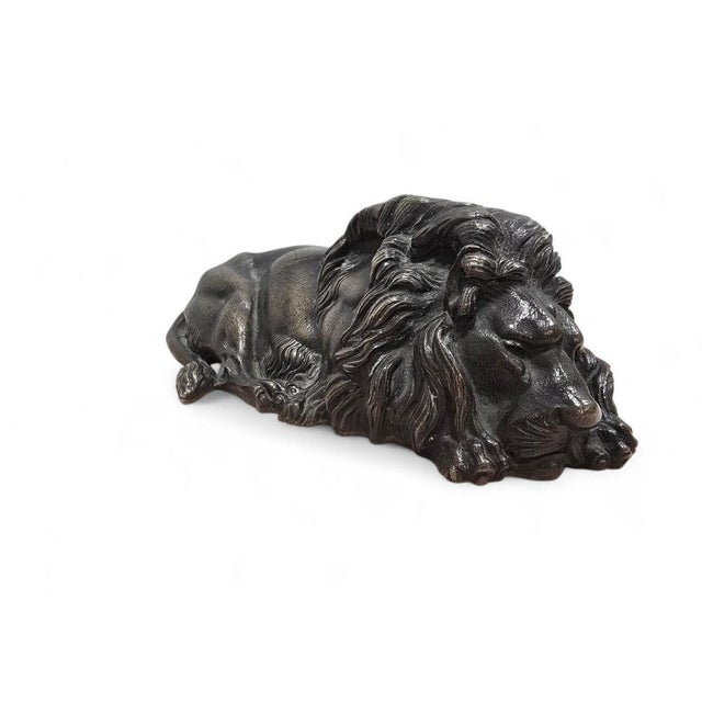 The lion is portrayed at rest, yet remains alert and powerful, reflecting the traditional symbolism of the king of beasts...