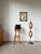 Antique floor lamp with a black patinated hammered bronze base and a tall stem supporting two light sources with galalith...