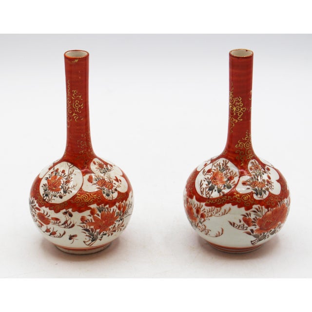 Circa 1870 pair of small bottle form Kutani vases, Japan. Delicate, long, narrow necks to bulbous bodies. Decorated with...