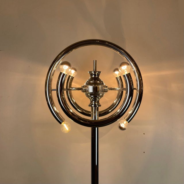 A striking and sculptural floor lamp made of chromed metal tubes with six light bulbs and a heavy marble base. Design...
