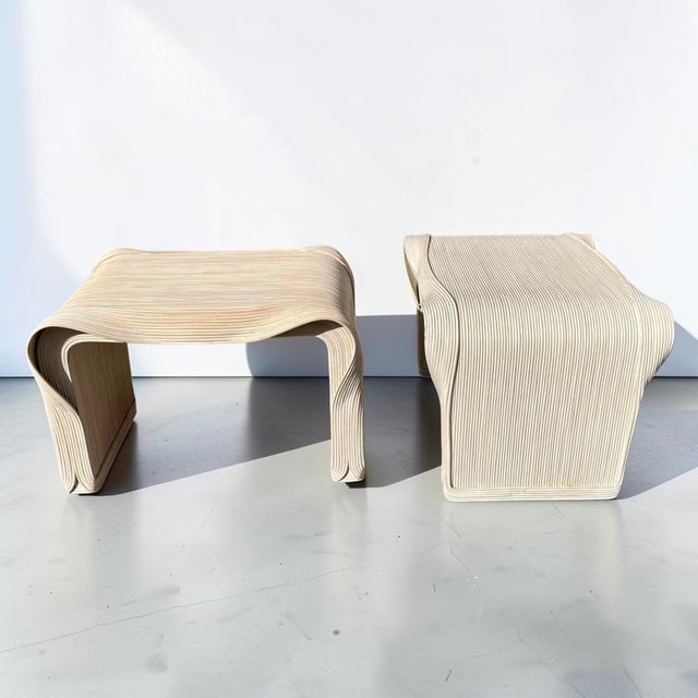 Stunning vintage sculptural pencil reed side tables. This piece is a 1980’s boho-chic pair of wooden end tables, with...