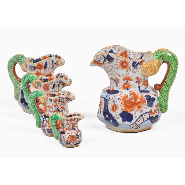 An antique set of five Mason’s Ironstone graduated Hydra jugs in bold Imari colors of cobalt blue and orange with a green...