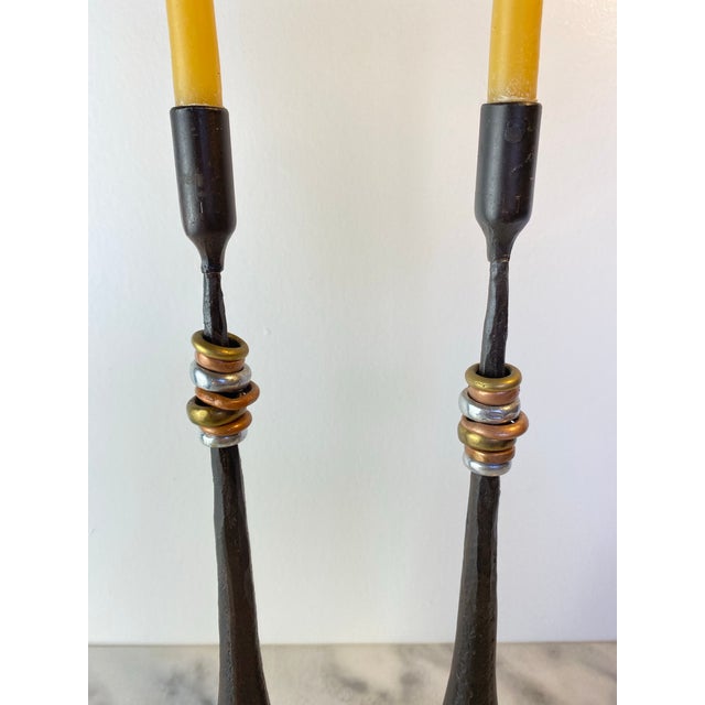 Striking pair of Luis Marquez Sekoya Originals rustic candlestick holders crafted from forged iron with sculptural stems...