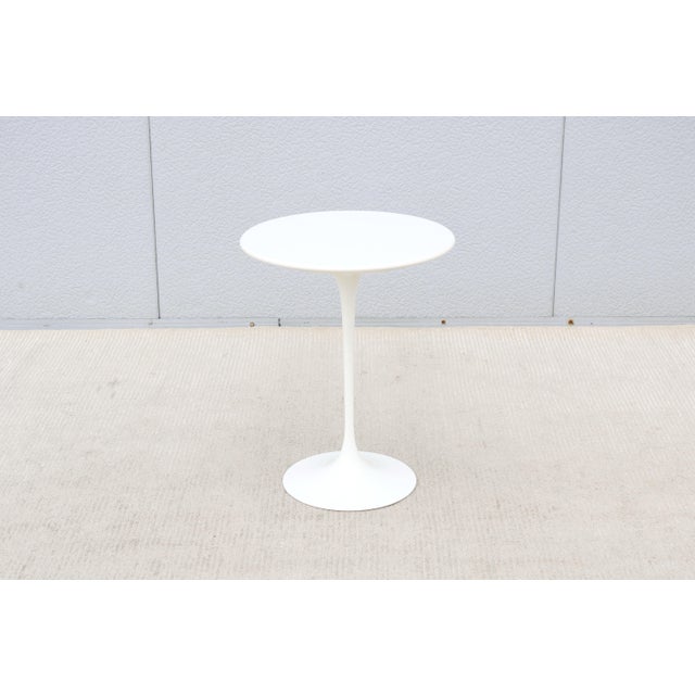 Fabulous 16" round white laminate top side table designed by Eero Saarinen for Knoll. It was introduced in 1956 and...