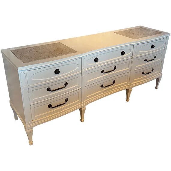 This piece is a French Country / Louis XVI–inspired triple dresser with elegant, refined lines and a light, airy presence.