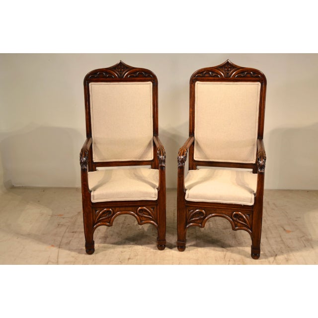 19th Century pair of English armchairs in the gothic manner. They have wonderfully carved frames and are newly upholstered...