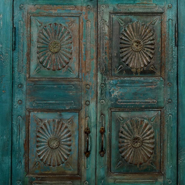 Crafted from antique Indian teakwood doors and reclaimed architectural elements, this armoire blends history, artistry,...